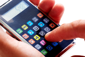 Hand with calculator.