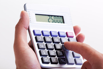 Hand with calculator.