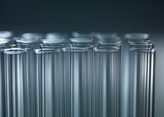 Aligned experimental glass test tubes in lab
