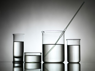 beakers with dropper and transparent liquid substance
