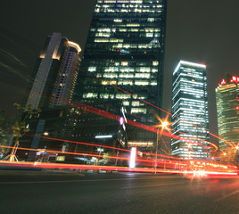 Modern office building background of car night with light trails
