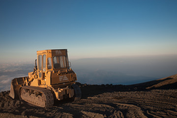 Fototapeta premium Bulldozer at the top of the Etna