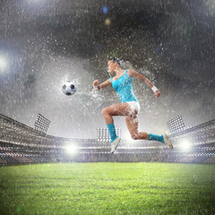 Fototapeta na wymiar Young woman football player