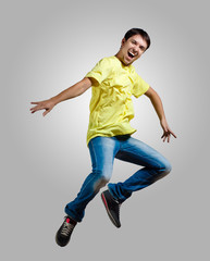 Fototapeta na wymiar Young man dancing and jumping