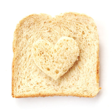 Sliced Whole Wheat Bread With Heart Shape On White Background