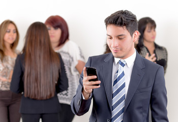 Hispanic man using a cellphone with peers