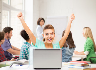 happy student girl with laptop at school