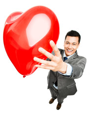 businessman holding red heart balloon