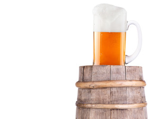 Beer glass on wooden vintage barrel