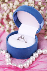 engagement ring on pink cloth
