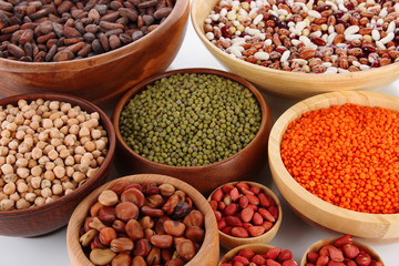 Different kinds of beans in bowls close-up