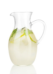 Lemonade in pitcher isolated on white