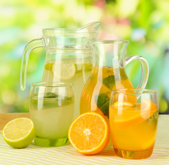 Orange and lemon lemonade in pitchers and glasses