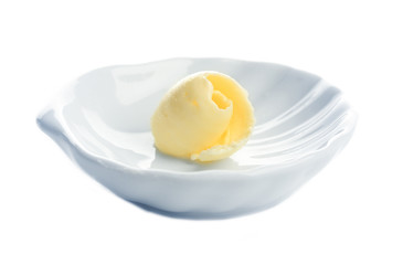 Butter curl on plate, isolated on white