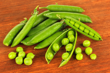 Sweet green peas on wooden background