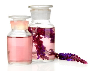 Medicine bottles with salvia flowers, isolated on white
