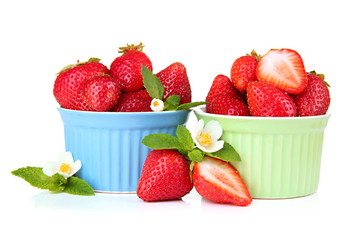 Ripe sweet strawberries in bowls, isolated on white