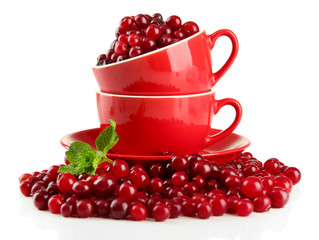 Ripe red cranberries in cups, isolated on white.