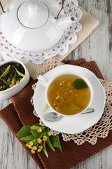 Cup of tea with linden on napkins on    wooden table