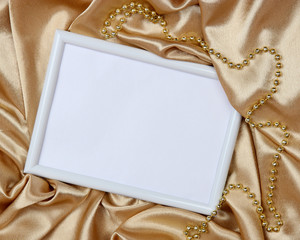 Fototapeta premium Empty frame on beautiful silk background