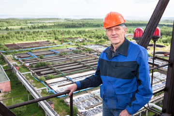 Smiling worker standing for high altitude platform. Copyspace