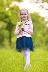 cute little blond girl with flowers