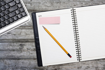 keyboard,diary book on wooden table.