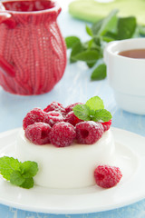 Vanilla panna cotta with raspberries.