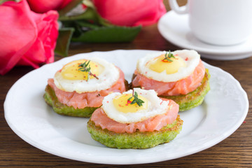 Snack of pancakes with fish and egg.