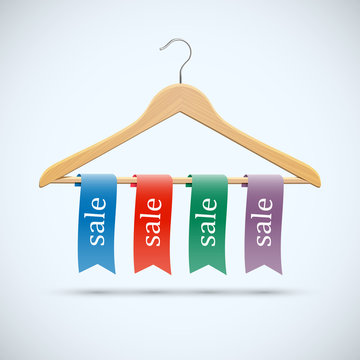 Sale concept - wooden hangers with colored ribbons