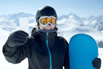 Snowboard girl with blank card smiling