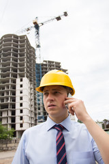 man in a hard hat talking on the phone