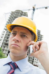 man in a hard hat talking on the phone