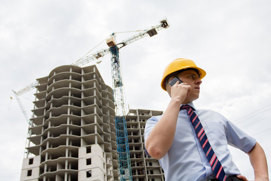 man in a hard hat talking on the phone