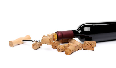 bottle of wine, corks and corkscrew.