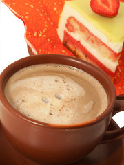 Cup of latte coffee with cake