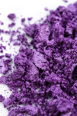 Crushed purple eye shadow on white background