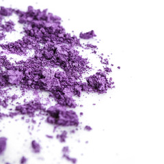 Crushed purple eye shadow on white background