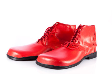 Very big red clown shoes on white