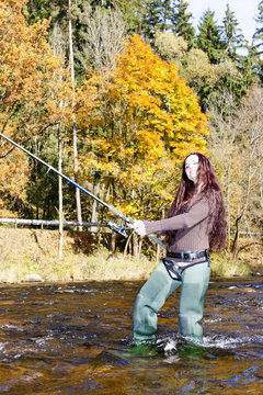 woman fishing in Otava river, Czech Republic