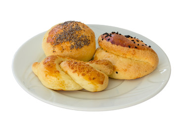 Fresh bread rolls on a plate, isolated on a white background