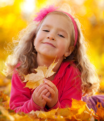 Happy girl in autumn park