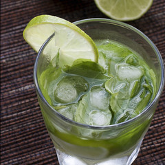 Mojito   with crushed ice and lime on a wicker tablecloth