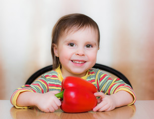 Fototapeta na wymiar Happy Kid with red pepper