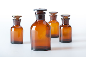 Small chemical glass bottles on white background