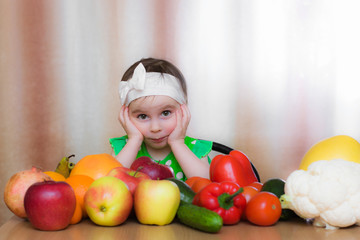 Fototapeta na wymiar Happy Kid with vegetables and fruits.