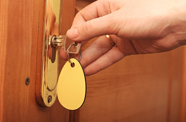 Hand, women are unlocked door