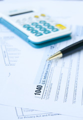 U.S. Tax form, pen and calculator