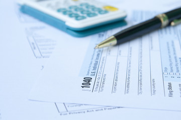 Naklejka na ściany i meble U.S. Tax form, pen and calculator