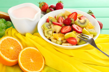 Useful fruit salad of fresh fruits and berries in bowl